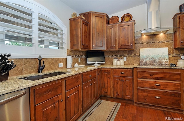 kitchen with sink, tasteful backsplash, wall chimney range hood, and dishwasher