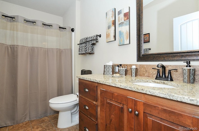 bathroom featuring toilet and vanity