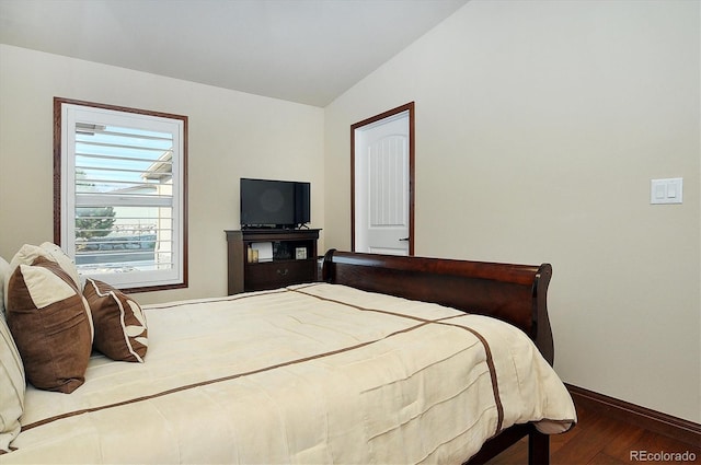 bedroom featuring vaulted ceiling and wood-type flooring