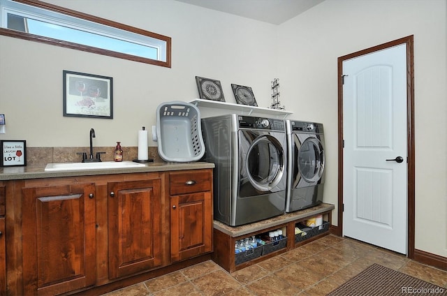 laundry area featuring sink, cabinets, and independent washer and dryer