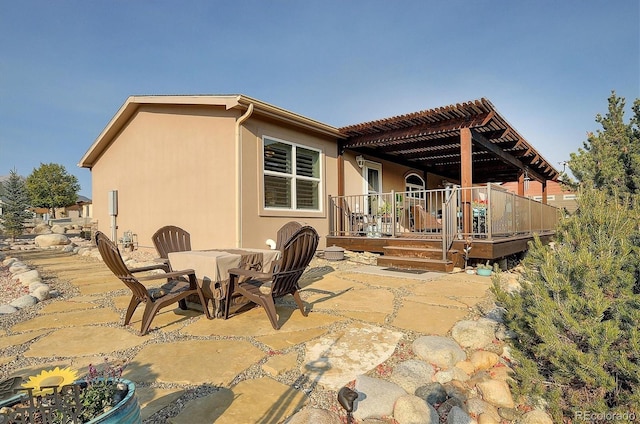 view of patio with a pergola and a deck