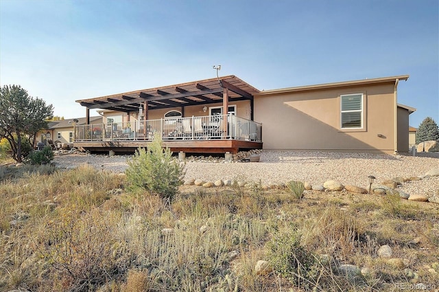 rear view of house with a wooden deck