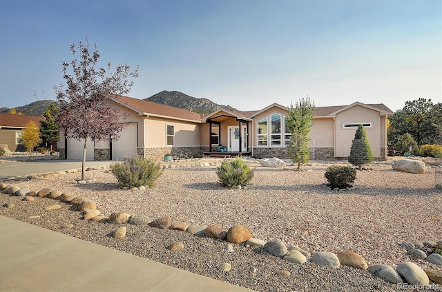 view of front facade with a garage and a mountain view