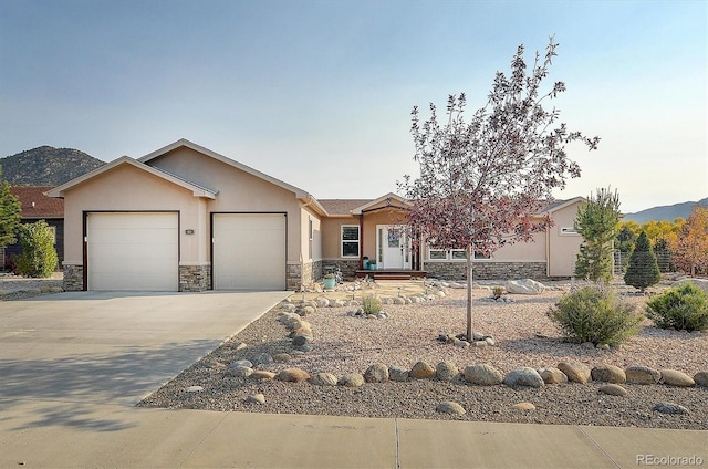 view of front facade with a garage and a mountain view