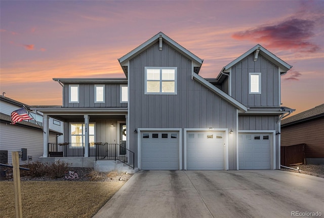 view of front of property with an attached garage, covered porch, board and batten siding, and concrete driveway