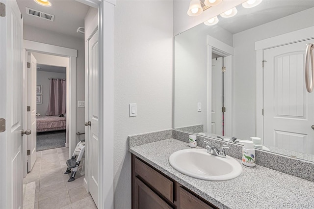 bathroom featuring tile patterned flooring, visible vents, and vanity