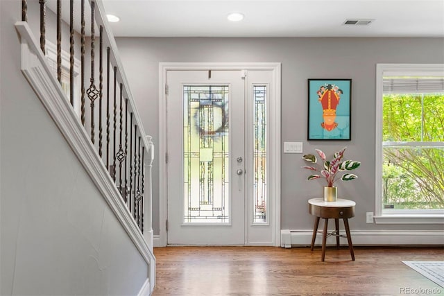 3330 E Tennessee Ave, Denver, CO 80209 - entryway featuring a baseboard heating unit, wood finished floors, stairway, recessed lighting, and baseboards