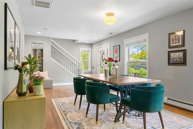 3330 E Tennessee Ave, Denver, CO 80209 - dining room featuring stairway, wood finished floors, recessed lighting, baseboards, and a baseboard heating unit