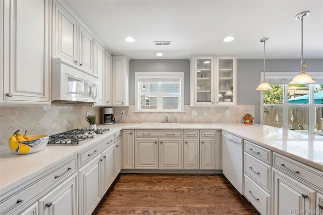 3330 E Tennessee Ave, Denver, CO 80209 - kitchen featuring white appliances, a sink, glass insert cabinets, backsplash, and recessed lighting