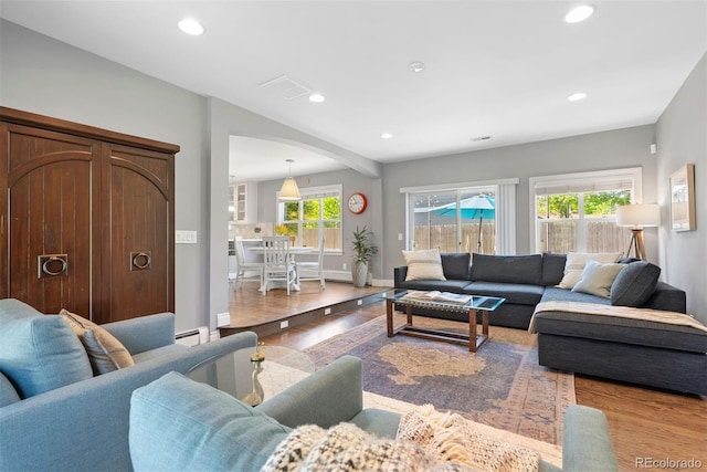 3330 E Tennessee Ave, Denver, CO 80209 - living area with wood finished floors, recessed lighting, baseboards, and a baseboard heating unit