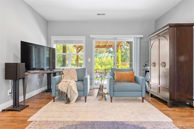 3330 E Tennessee Ave, Denver, CO 80209 - sitting room with plenty of natural light, wood finished floors, and baseboards