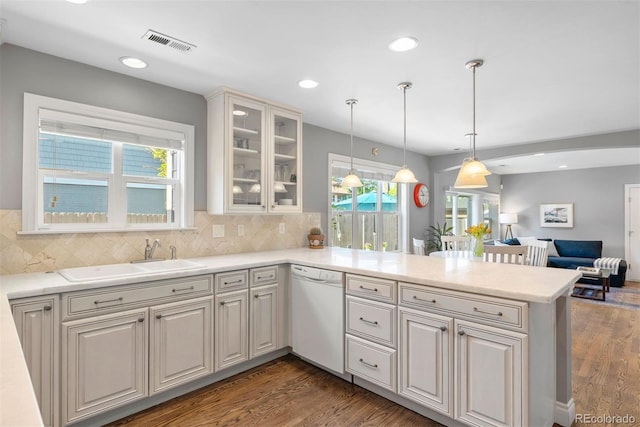 3330 E Tennessee Ave, Denver, CO 80209 - kitchen featuring dishwasher, a sink, open floor plan, a peninsula, and wood finished floors