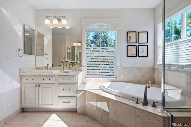 3330 E Tennessee Ave, Denver, CO 80209 - bathroom featuring vanity, a garden tub, plenty of natural light, and tile patterned flooring