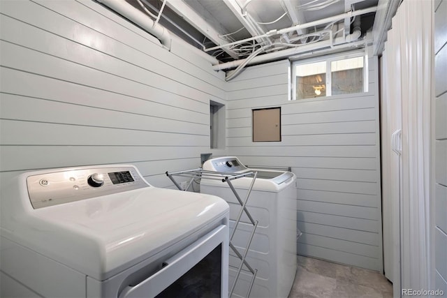 3330 E Tennessee Ave, Denver, CO 80209 - laundry room with washer and clothes dryer and wood walls