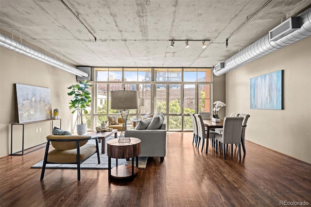1499 Blake St Unit 2C, Denver, CO 80202 - living area featuring expansive windows, wood finished floors, plenty of natural light, and rail lighting