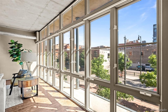 1499 Blake St Unit 2C, Denver, CO 80202 - unfurnished sunroom featuring wood finished floors and plenty of natural light