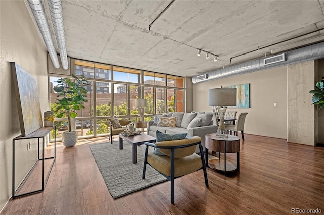 1499 Blake St Unit 2C, Denver, CO 80202 - living room with expansive windows, wood finished floors, and track lighting