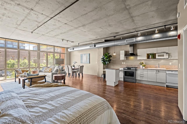 1499 Blake St Unit 2C, Denver, CO 80202 - bedroom with dark wood finished floors and track lighting