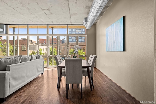 1499 Blake St Unit 2C, Denver, CO 80202 - dining space featuring dark wood-style flooring, a textured wall, plenty of natural light, and floor to ceiling windows