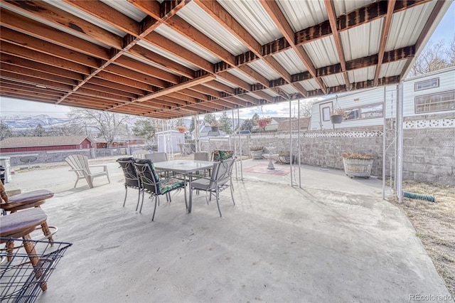 view of patio with outdoor dining area and fence