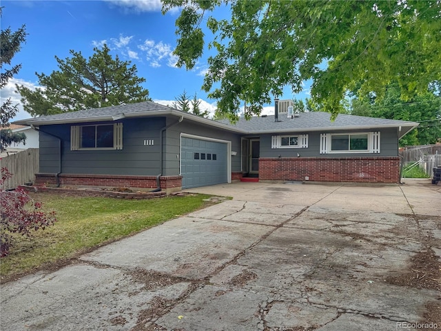 1111 Royale Dr, Colorado Springs, CO 80910 - ranch-style home with a garage, driveway, and brick siding