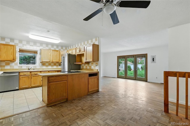 1111 Royale Dr, Colorado Springs, CO 80910 - kitchen featuring appliances with stainless steel finishes, light countertops, healthy amount of natural light, and a peninsula