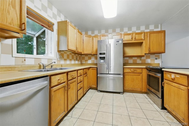1111 Royale Dr, Colorado Springs, CO 80910 - kitchen featuring stainless steel appliances, light countertops, light tile patterned flooring, and tasteful backsplash