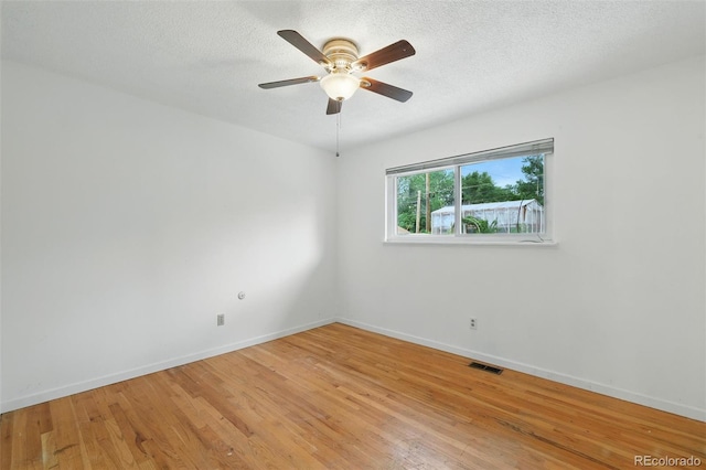 1111 Royale Dr, Colorado Springs, CO 80910 - unfurnished room with light wood finished floors, a ceiling fan, and a textured ceiling
