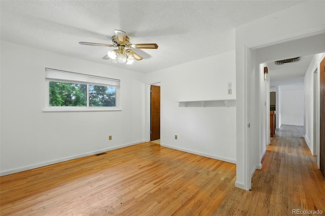 1111 Royale Dr, Colorado Springs, CO 80910 - unfurnished room with light wood finished floors, a ceiling fan, and a textured ceiling