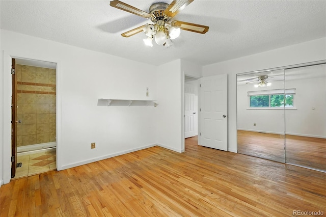 1111 Royale Dr, Colorado Springs, CO 80910 - unfurnished bedroom with light wood-style floors, a closet, ensuite bath, a textured ceiling, and ceiling fan