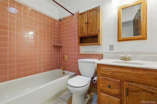 1111 Royale Dr, Colorado Springs, CO 80910 - full bath featuring vanity,  shower combination, tile walls, and tile patterned flooring