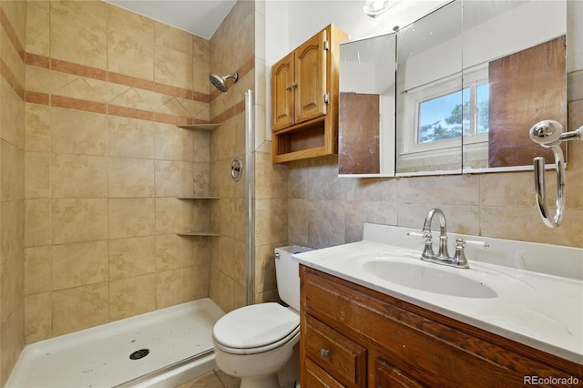 1111 Royale Dr, Colorado Springs, CO 80910 - bathroom featuring vanity, a tile shower, tile walls, and decorative backsplash