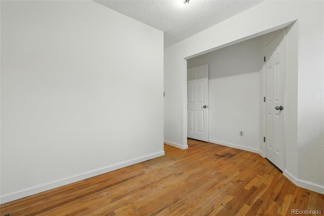 1111 Royale Dr, Colorado Springs, CO 80910 - unfurnished room with light wood finished floors and a textured ceiling