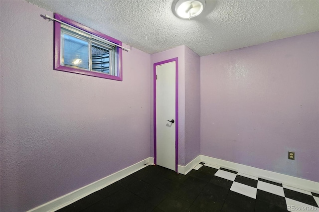 1111 Royale Dr, Colorado Springs, CO 80910 - empty room featuring a textured ceiling and dark flooring
