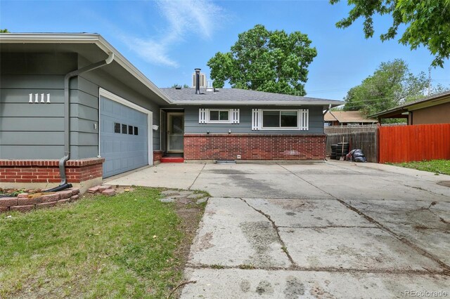1111 Royale Dr, Colorado Springs, CO 80910 - ranch-style house with brick siding, concrete driveway, and an attached garage