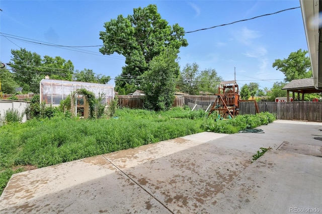 1111 Royale Dr, Colorado Springs, CO 80910 - fenced backyard featuring a patio area, an exterior structure, a playground, and an outdoor structure
