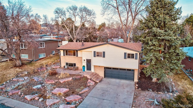 view of front of house featuring a garage, concrete driveway, and brick siding