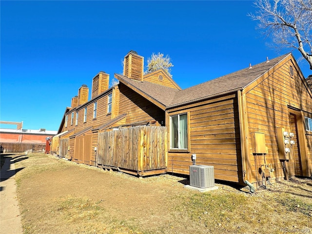 view of side of property with central air condition unit