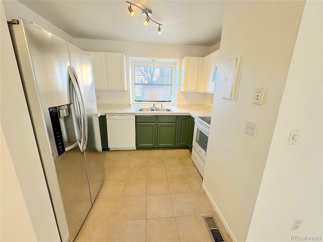 kitchen with sink, white cabinets, white appliances, light tile patterned floors, and green cabinetry