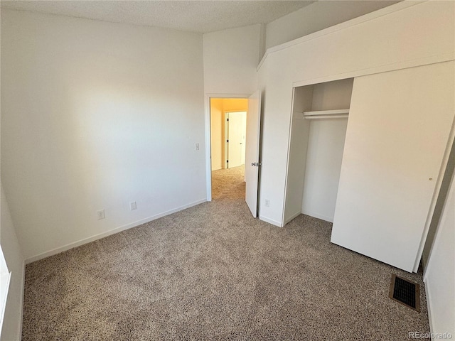 unfurnished bedroom featuring carpet floors and a closet