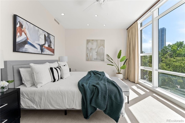 carpeted bedroom with recessed lighting and visible vents