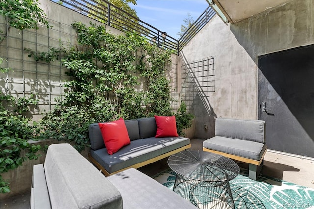 view of patio / terrace featuring an outdoor living space and fence