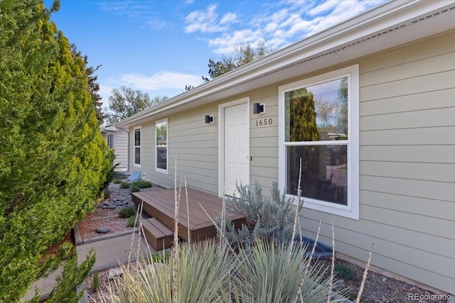 view of home's exterior with a wooden deck