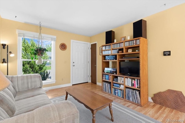 living area with wood finished floors and baseboards