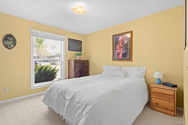bedroom featuring carpet floors, a textured ceiling, and baseboards