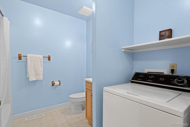 laundry room with washer / clothes dryer, light floors, and baseboards