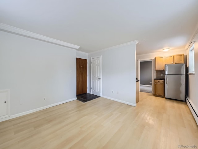 unfurnished living room featuring light wood-style flooring, ornamental molding, baseboards, and a baseboard radiator