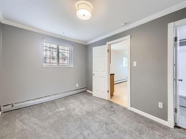 unfurnished bedroom with a baseboard heating unit, baseboards, carpet floors, and ornamental molding