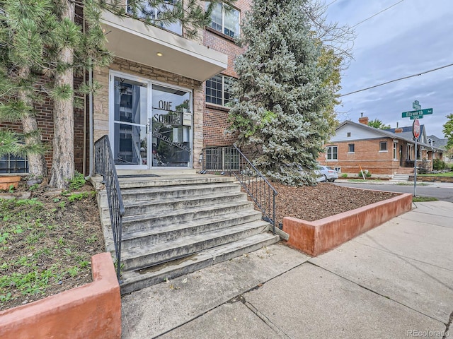 entrance to property with brick siding