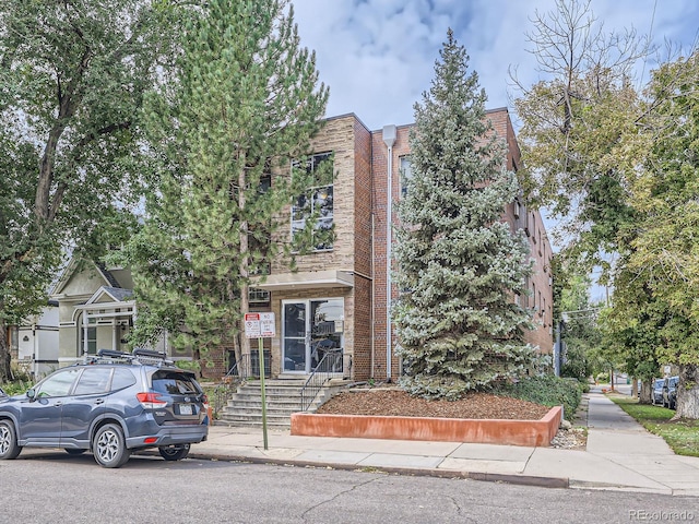 view of front of home featuring brick siding